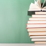 Open book, hardback books on wooden table. Education background. Back to school. Copy space for text.