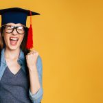 Study, education, university, college, graduate concept on banner. Happy and excited portrait of young student girl in hat of graduation isolated